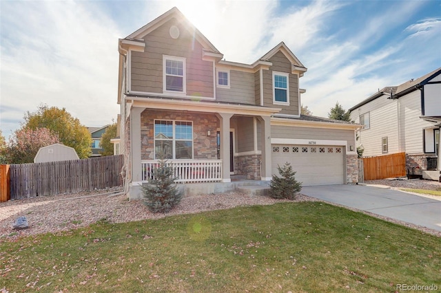 craftsman house featuring covered porch, a front lawn, and a garage