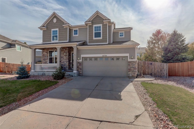 craftsman-style house featuring covered porch, a garage, and a front lawn