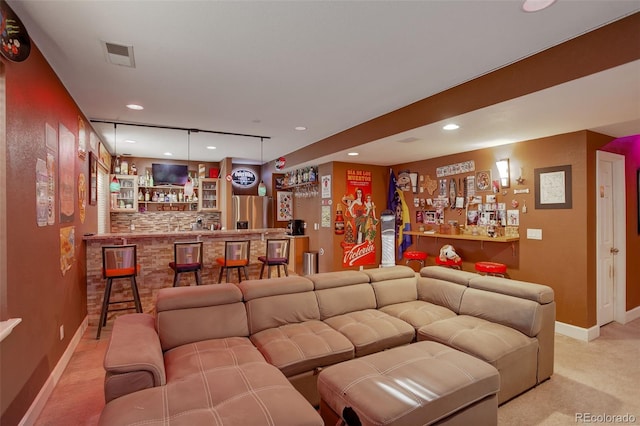 carpeted living room featuring bar