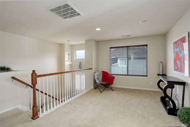 sitting room featuring light colored carpet