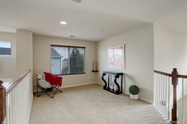 sitting room featuring light carpet and plenty of natural light