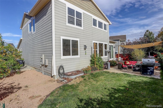 back of property with a patio area and a lawn