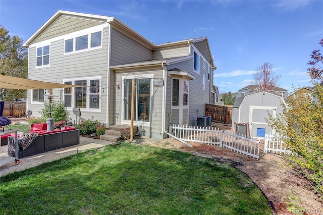 rear view of house with a patio, a storage unit, a yard, and an outdoor living space