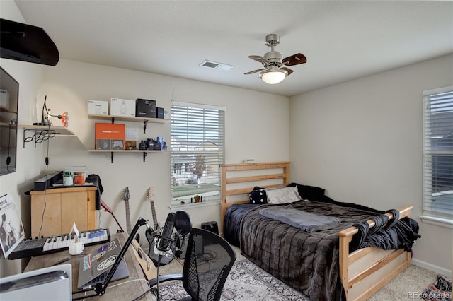 bedroom with light carpet and ceiling fan