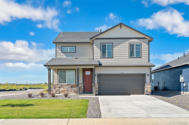 view of front of house featuring a front lawn, central AC unit, and a garage