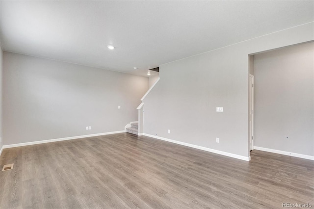 unfurnished room featuring hardwood / wood-style flooring