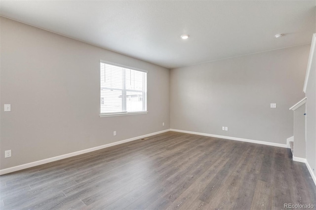 unfurnished room featuring dark wood-type flooring