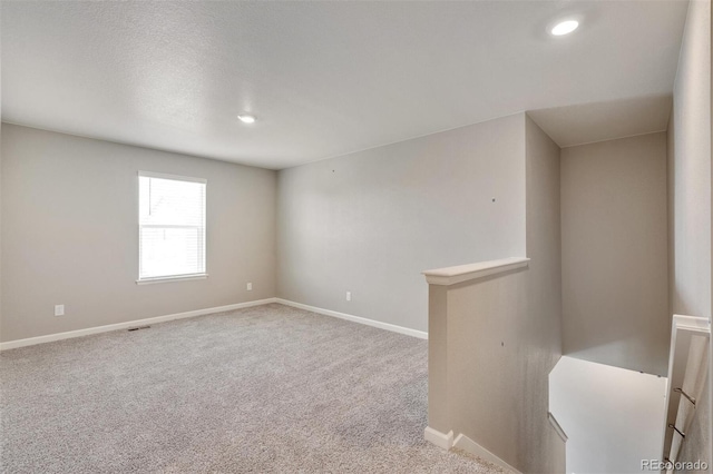 empty room with light colored carpet