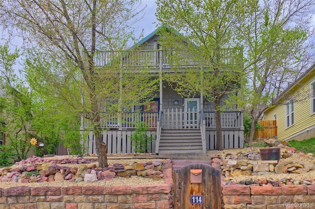 114 N 7th St, Colorado Springs, CO 80905 - view of front of property featuring covered porch, fence, and stairs