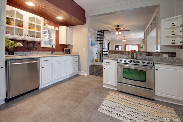 114 N 7th St, Colorado Springs, CO 80905 - kitchen featuring decorative backsplash, ceiling fan, appliances with stainless steel finishes, a sink, and white cabinetry