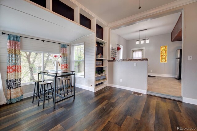 114 N 7th St, Colorado Springs, CO 80905 - dining area with baseboards, ornamental molding, wood finished floors, and visible vents