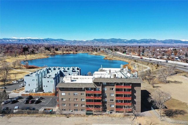 birds eye view of property with a water and mountain view