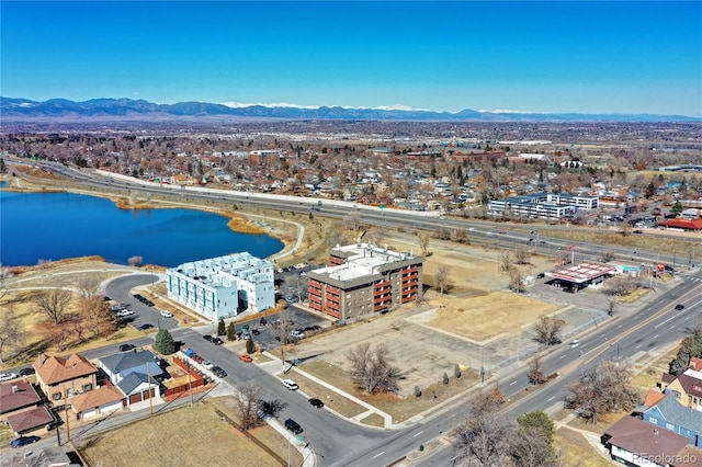 drone / aerial view featuring a water and mountain view