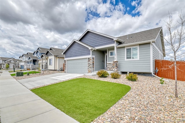 12718 Windingwalk Dr, Peyton, CO 80831 - craftsman house featuring concrete driveway, an attached garage, a residential view, and stone siding