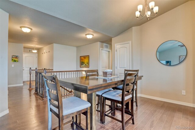 12718 Windingwalk Dr, Peyton, CO 80831 - dining space with baseboards, light wood-style flooring, and a chandelier