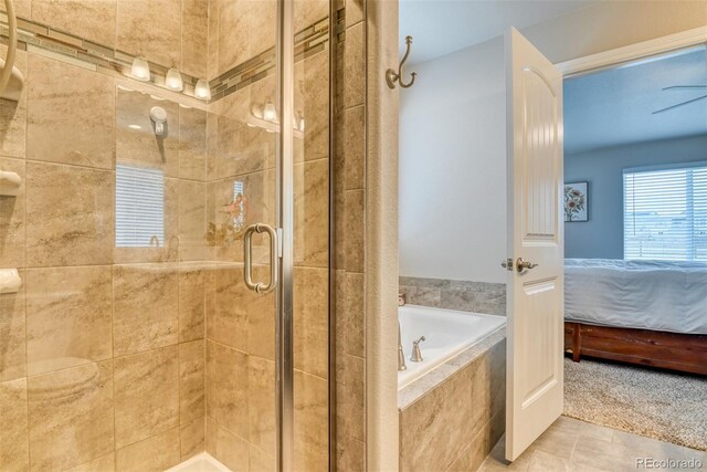 12718 Windingwalk Dr, Peyton, CO 80831 - ensuite bathroom with a bath, a stall shower, and tile patterned floors