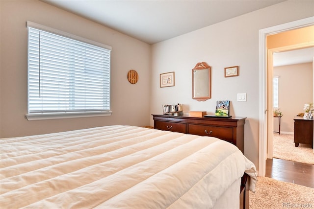12718 Windingwalk Dr, Peyton, CO 80831 - bedroom featuring wood finished floors and multiple windows