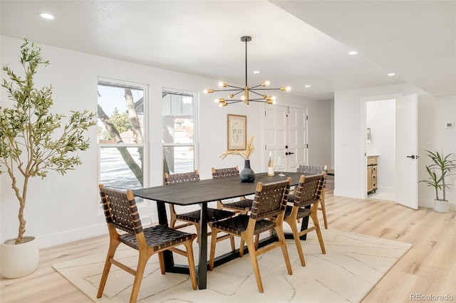 dining area featuring a chandelier and light wood-type flooring