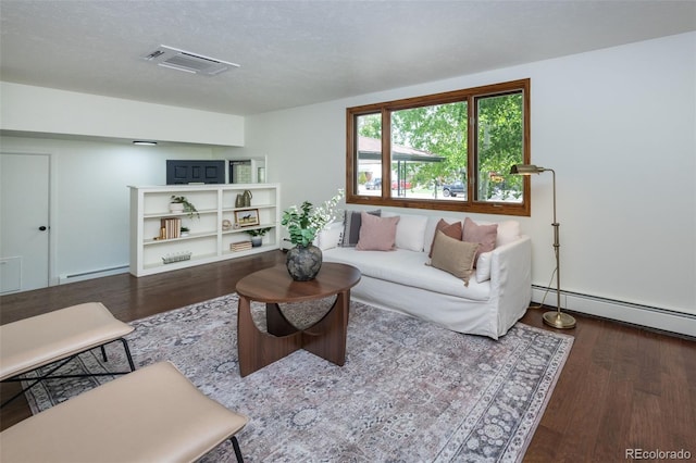 living room with a textured ceiling, a baseboard heating unit, and dark wood-type flooring