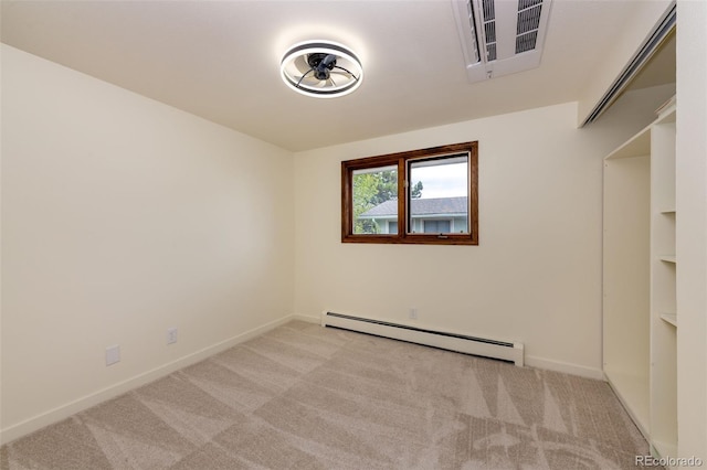 carpeted spare room featuring a baseboard radiator