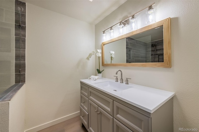 bathroom featuring vanity and a tile shower