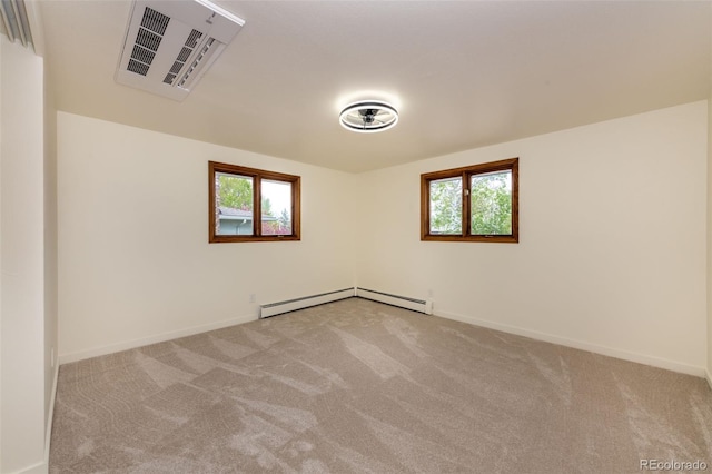 empty room featuring a healthy amount of sunlight, carpet floors, and a baseboard radiator