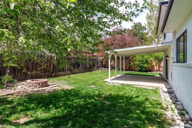 view of yard with a patio area and an outdoor fire pit