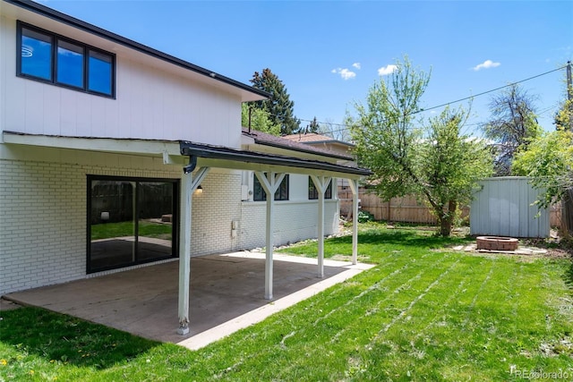 view of yard featuring a patio area and an outdoor fire pit