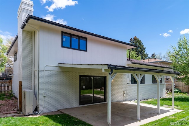 rear view of house featuring a patio and central AC