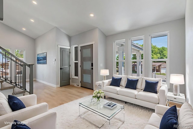 4740 W 108th Pl, Westminster, CO 80031 - living area with healthy amount of natural light, light wood-style flooring, stairway, recessed lighting, and lofted ceiling