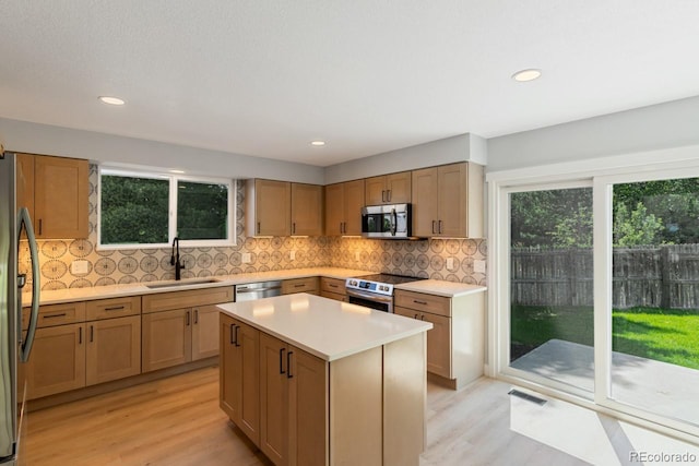4740 W 108th Pl, Westminster, CO 80031 - kitchen featuring stainless steel appliances, light wood-style flooring, light countertops, tasteful backsplash, and recessed lighting