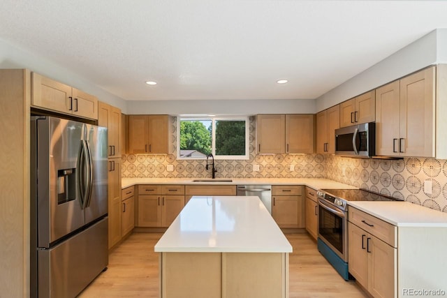 4740 W 108th Pl, Westminster, CO 80031 - kitchen with appliances with stainless steel finishes, light wood-type flooring, a center island, light countertops, and light brown cabinetry