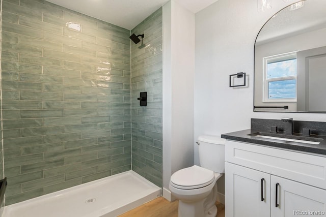 4740 W 108th Pl, Westminster, CO 80031 - bathroom with vanity, a tile shower, and wood finished floors