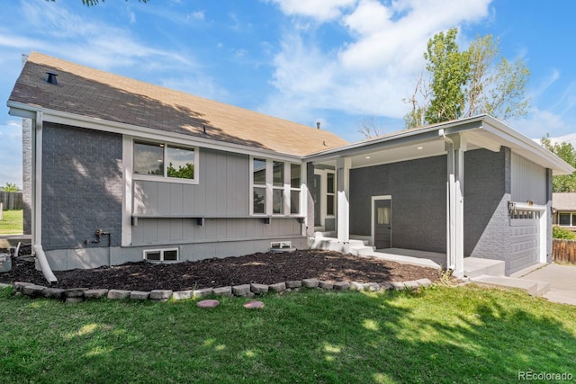 4740 W 108th Pl, Westminster, CO 80031 - back of house with a yard, brick siding, and driveway