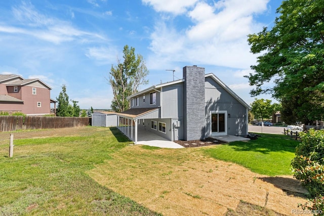 4740 W 108th Pl, Westminster, CO 80031 - back of house with a storage shed, a chimney, and a patio area