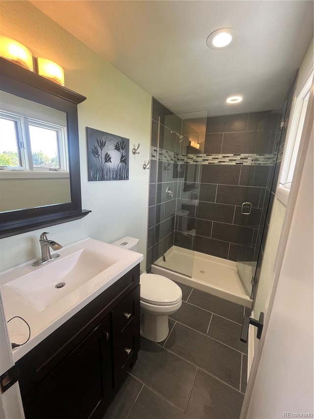 1158 E Easter Ct, Centennial, CO 80122 - full bathroom with tile patterned flooring, vanity, toilet, a stall shower, and recessed lighting