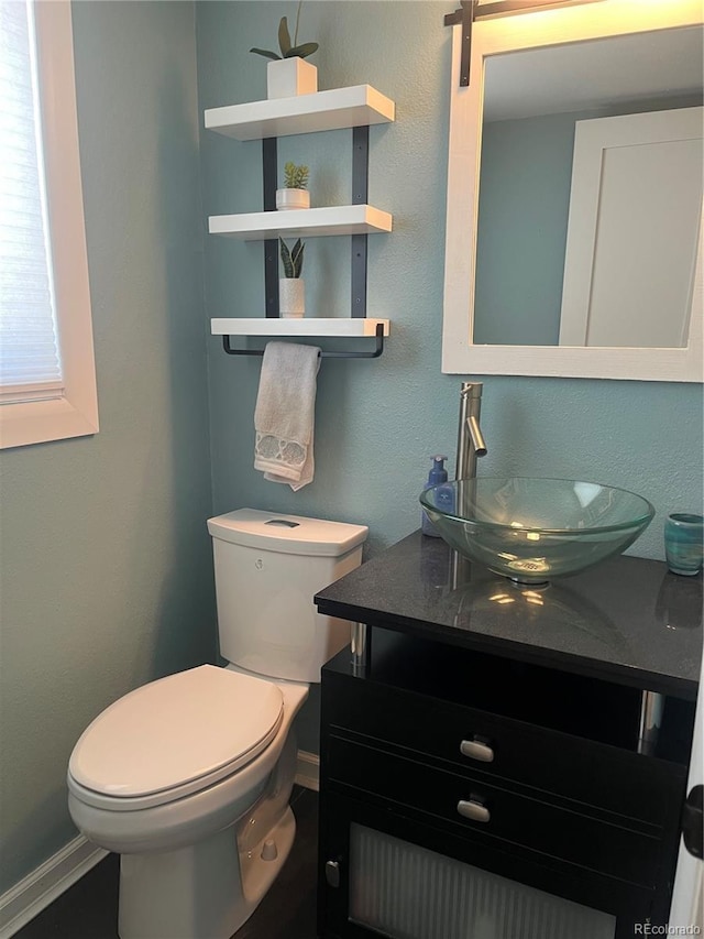 1158 E Easter Ct, Centennial, CO 80122 - half bathroom featuring vanity, toilet, and baseboards
