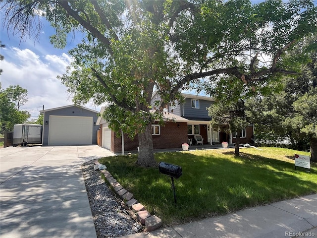 1158 E Easter Ct, Centennial, CO 80122 - view of property hidden behind natural elements with driveway, a front yard, a garage, and brick siding
