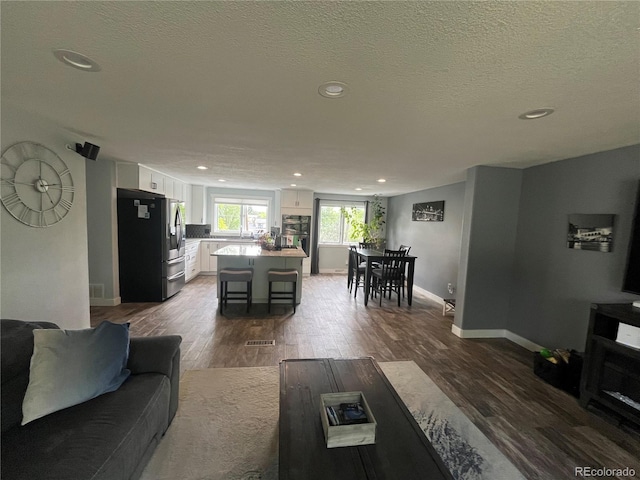 1158 E Easter Ct, Centennial, CO 80122 - living room featuring dark wood-style floors, recessed lighting, baseboards, and a textured ceiling