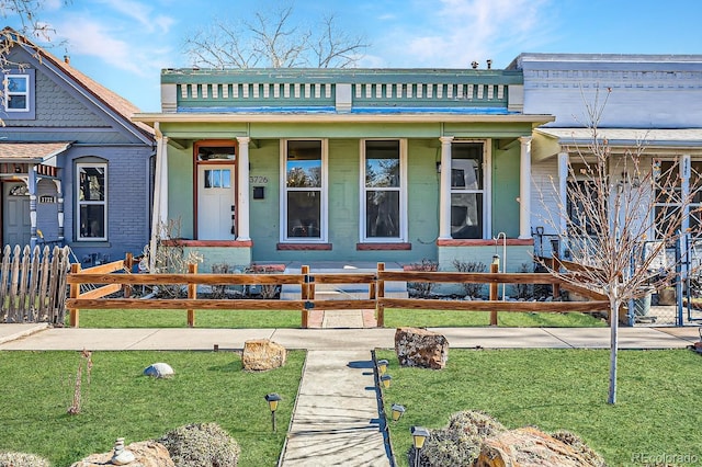 view of front of property featuring a fenced front yard and a balcony