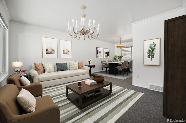 carpeted living room with ornamental molding, a healthy amount of sunlight, and an inviting chandelier