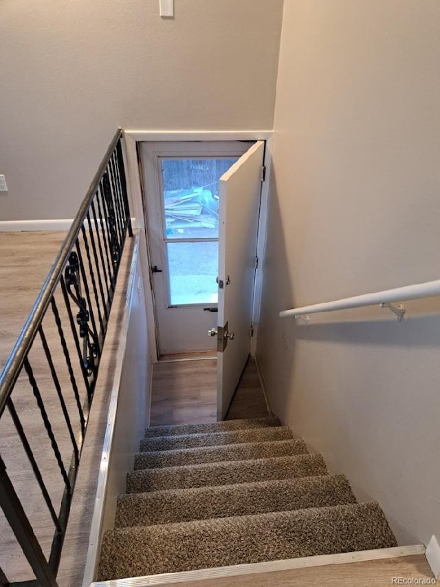 staircase with hardwood / wood-style floors