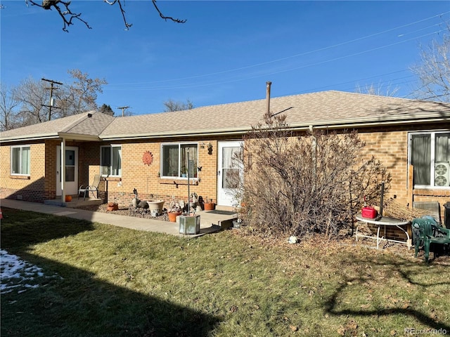 back of house with a lawn