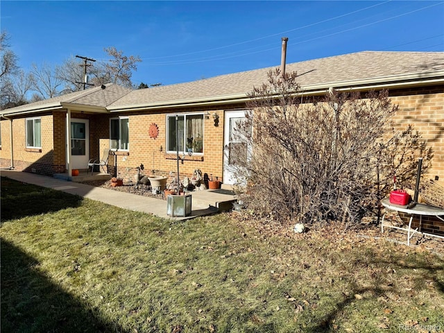 back of house with a lawn