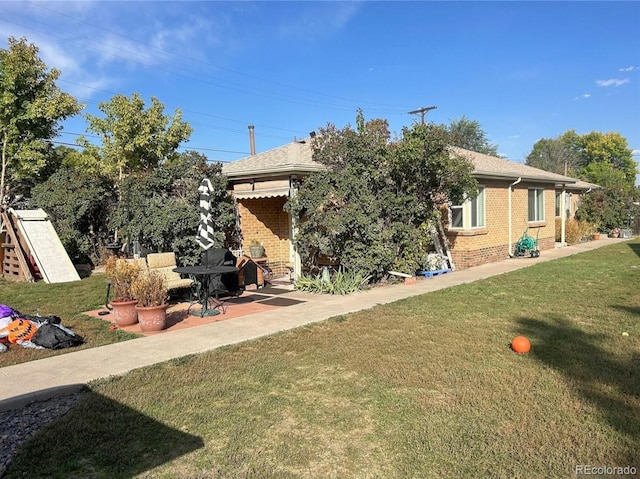 exterior space featuring a lawn and a patio