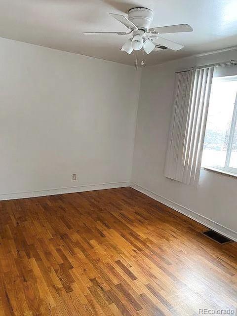 empty room featuring ceiling fan and wood-type flooring