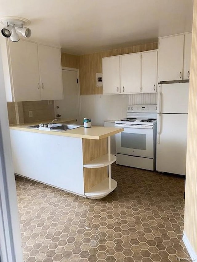 kitchen with white appliances, white cabinetry, and sink