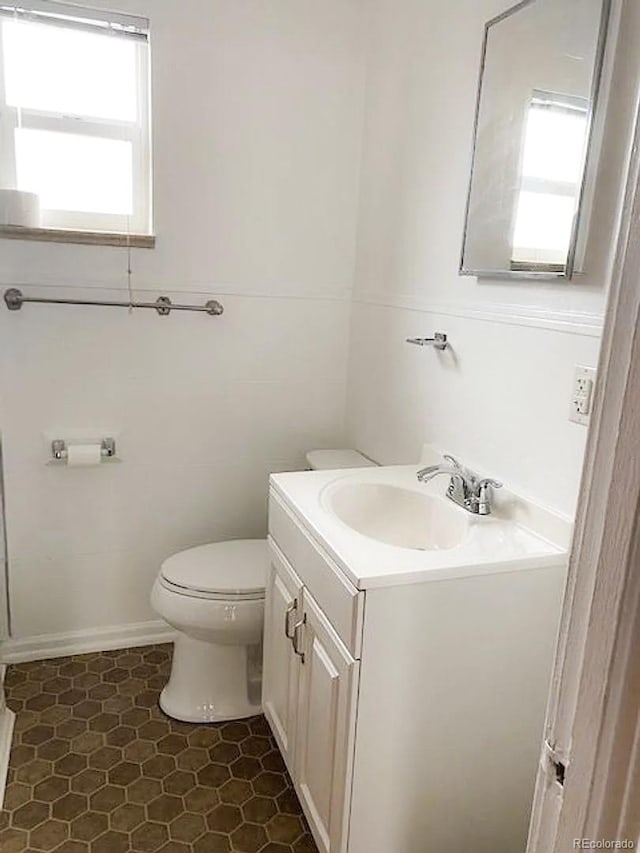 bathroom with tile patterned flooring, vanity, and toilet