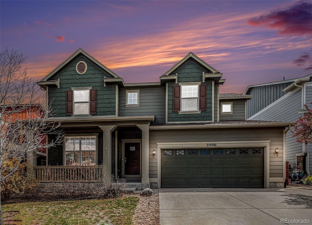 traditional home featuring a porch, a garage, and driveway