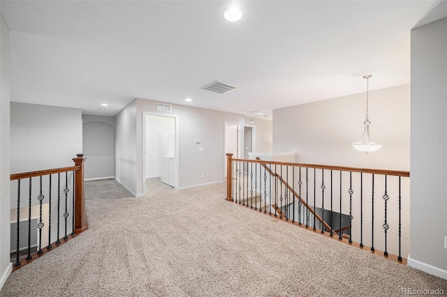 corridor featuring carpet floors, visible vents, recessed lighting, and an upstairs landing